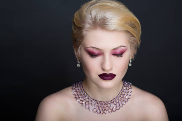 Creative makeup, new crazy conceptual idea for Halloween. burgundy red bold body art painting. Crazy new graphic abstract picture on woman face. shiny lipstick gloss lips Horizontal professional photo