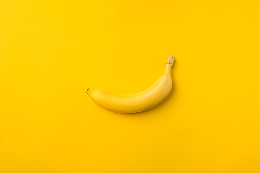 One ripe banana isolated on yellow