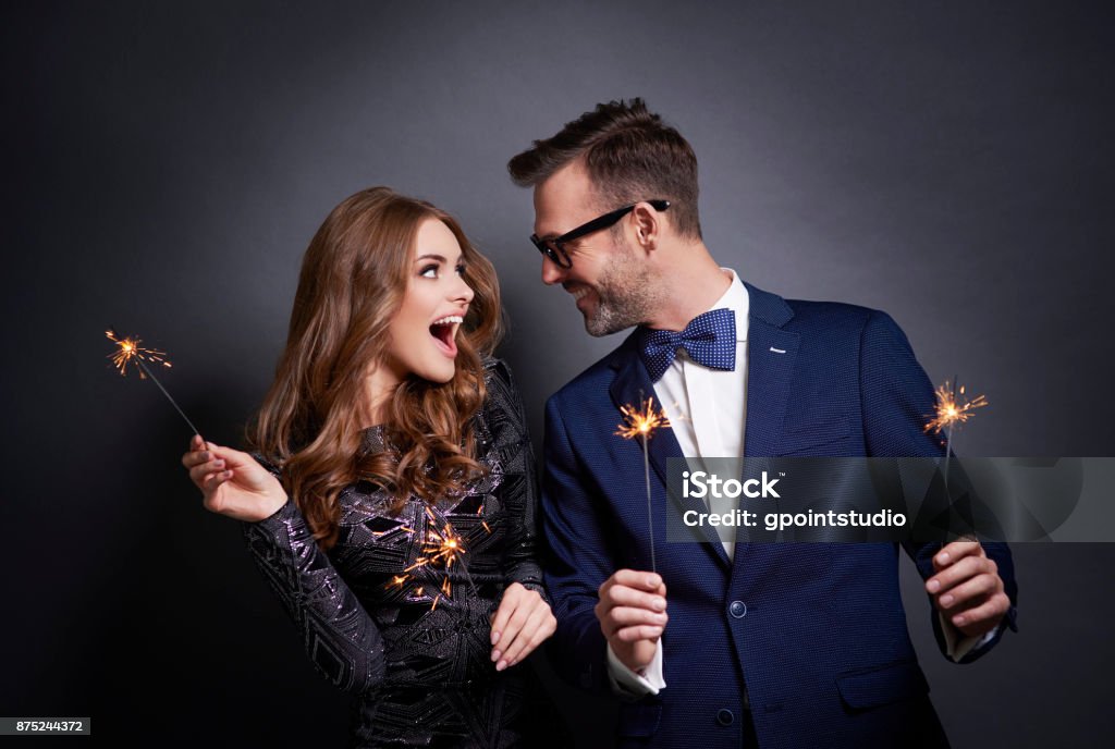 Cheerful couple with sparkler flirting Celebration Stock Photo