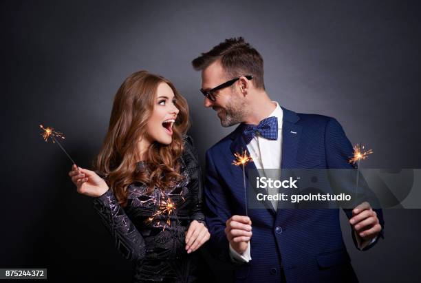Cheerful Couple With Sparkler Flirting Stock Photo - Download Image Now - Celebration, Couple - Relationship, Men