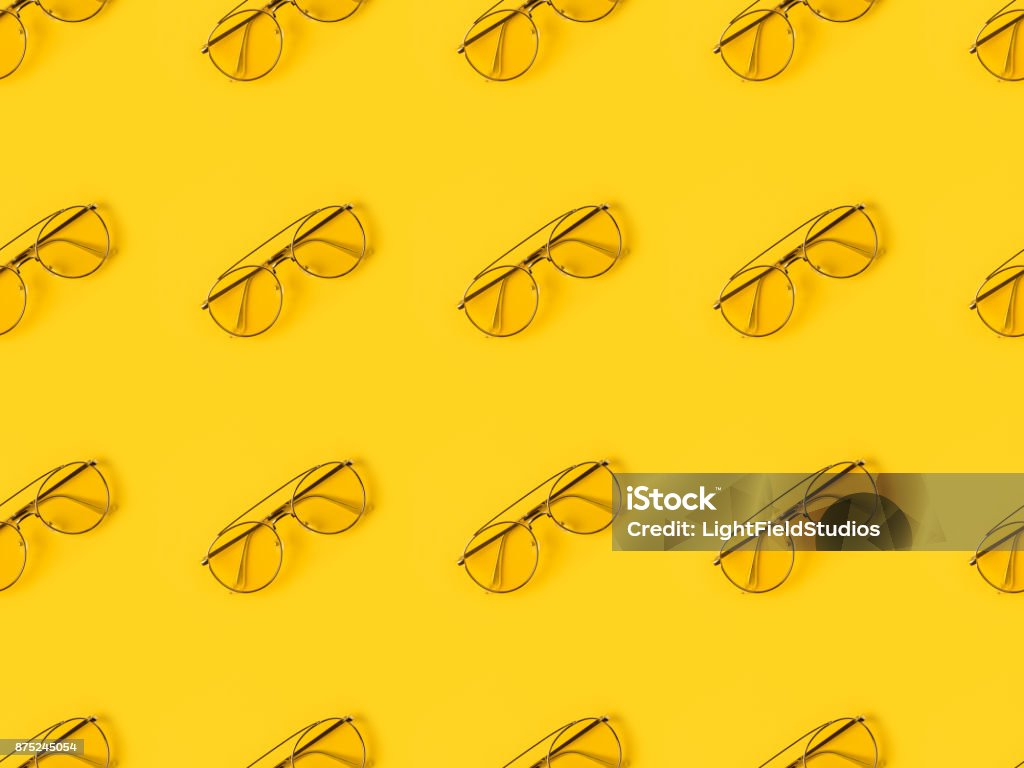 stylish Glasses isolated on yellow Set of stylish Glasses isolated on yellow Pattern Stock Photo