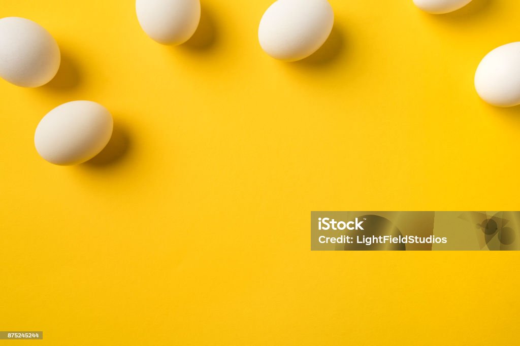 Natural Chicken eggs Top view of Natural Chicken eggs isolated on yellow Animal Egg Stock Photo