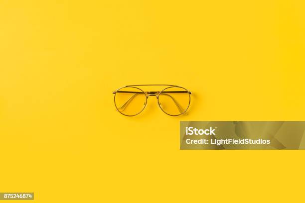 One Stylish Glasses Stock Photo - Download Image Now - Eyeglasses, Yellow Background, Yellow