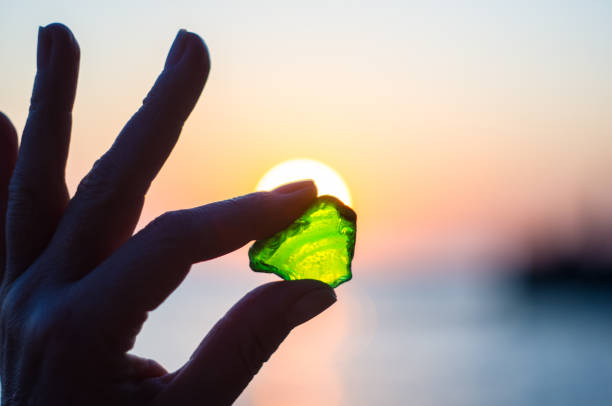 istock sea smoothed green glass in hand 875247220