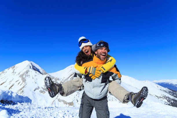 istock Young couple skiers having fun on top snow mountain 875250242