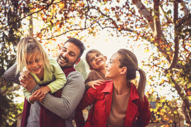 istock Smiling parents carrying daughters, have fun. 875252858