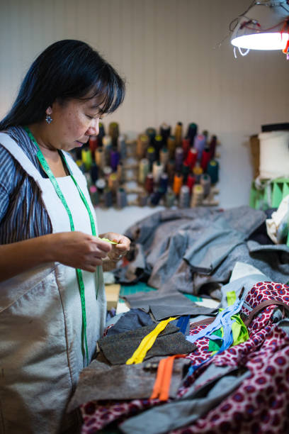 istock A female textile artist selecting a zipper for a hand made product 875253542