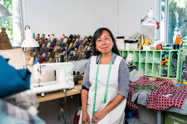 a female entrepreneur in her textile studio - independence business women manual worker imagens e fotografias de stock