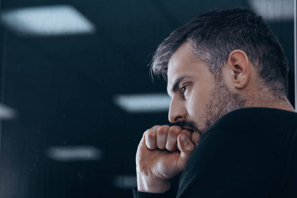 Nervous man in rehab center Nervous man with withdrawal symptoms in rehab center for druggies edgy man stock pictures, royalty-free photos & images