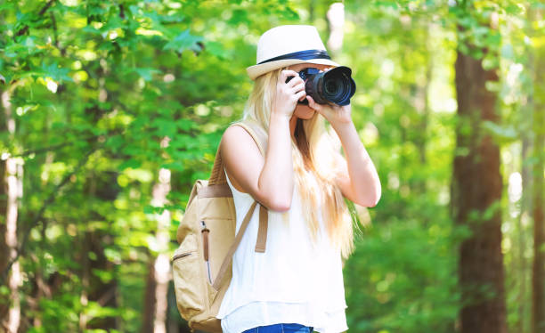 istock Female photographer with a camera outside 875255446