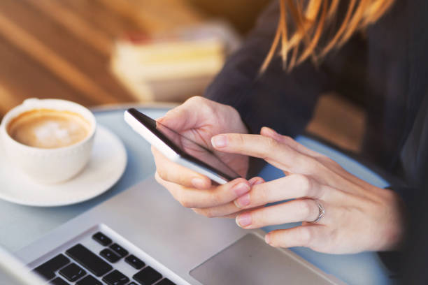 istock close up of hands using mobile application on smartphone 875258378