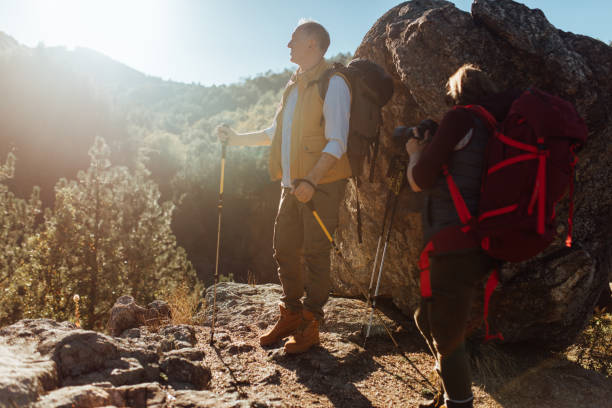istock Mature couple taking rest from hiking and enjoying nature 875258764