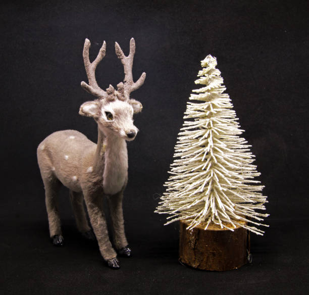 istock Winterly Christmas decoration with a deer in a forrest 875261334