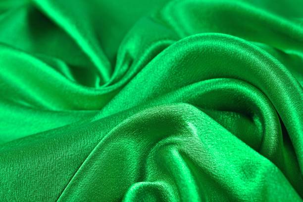 istock Natural green satin fabric texture background 875261612