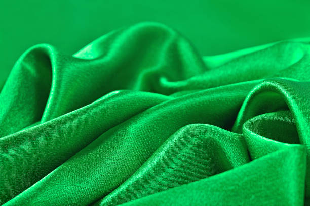 istock Natural green satin fabric texture background 875265042