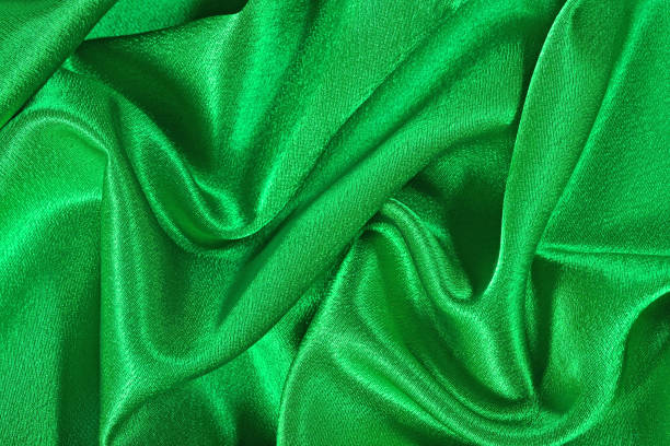 istock Natural green satin fabric texture background 875265908