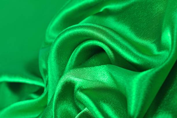 istock Natural green satin fabric texture background 875266400