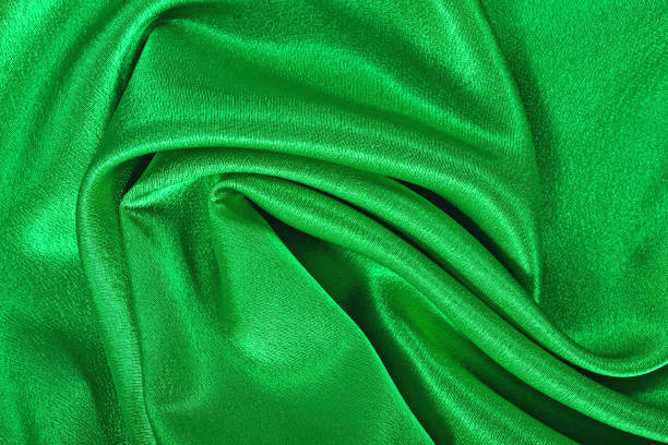 istock Natural green satin fabric texture background 875270444
