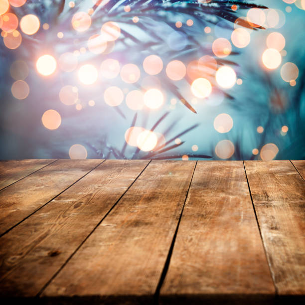 istock Pine tree backgound with empty wooden planks and defocused lights 875270524