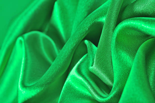 istock Natural green satin fabric texture background 875273010