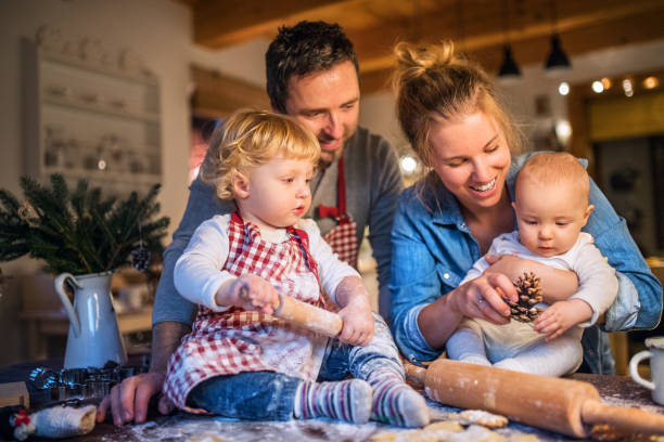 istock Young family making cookies at home. 875273372