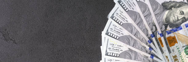 istock Hundreds american dollars on a black background 875273616