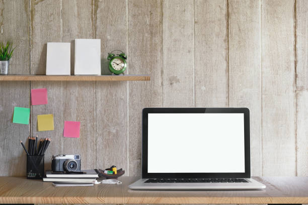 istock Workspace Mockup with laptop computer, Vitage camera, Books, films at home or studio. Mock up desk space and blank screen laptop for graphics display montage. 875273660
