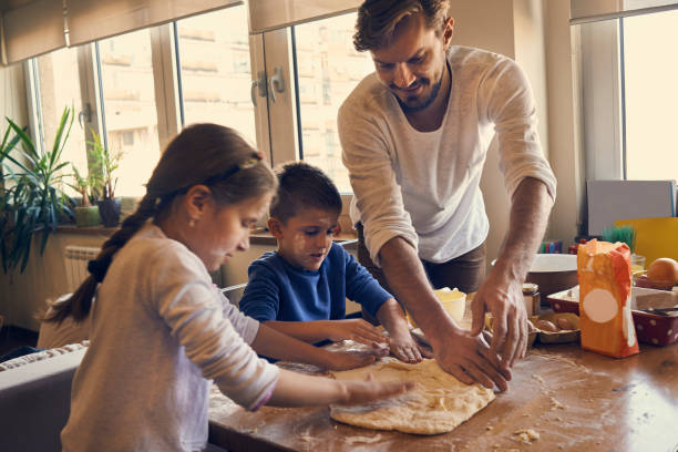 istock children enjoying baking with their father 875273776