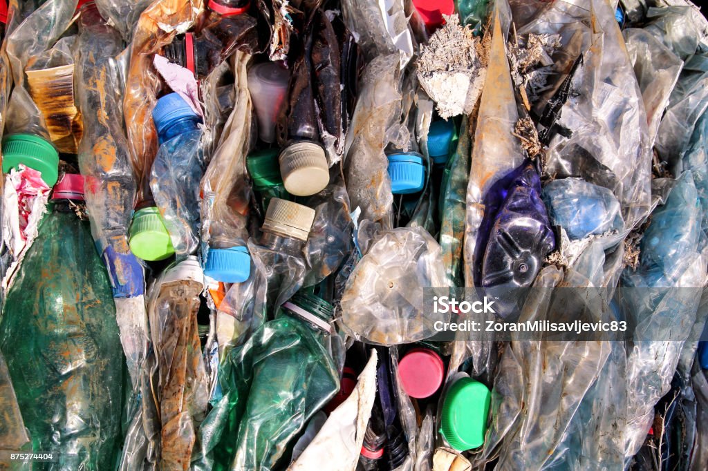 Plastic bottles on pile, ready to get recycled. Recycling of old plastic bottles. Pile of packed and recycling ready plastic bottles. Recycling industry. Ecology. Recycled material. Mass consumption. Bottle Stock Photo