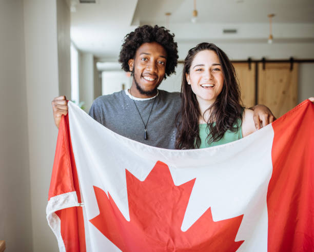 istock Couple holding Canadian Flag 875275020