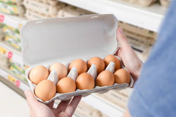 istock Man buys eggs in the supermarket 875280082