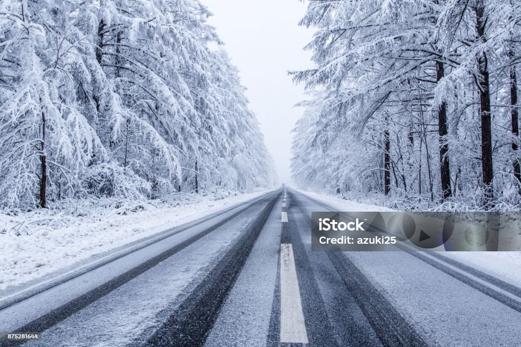 Frozen road, Hokaido,Japan. Road Passing Through Snowy Forest Road Stock Photo