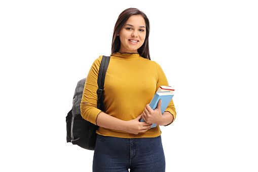 Female teen student with a backpack and books smiling isolated on white background
