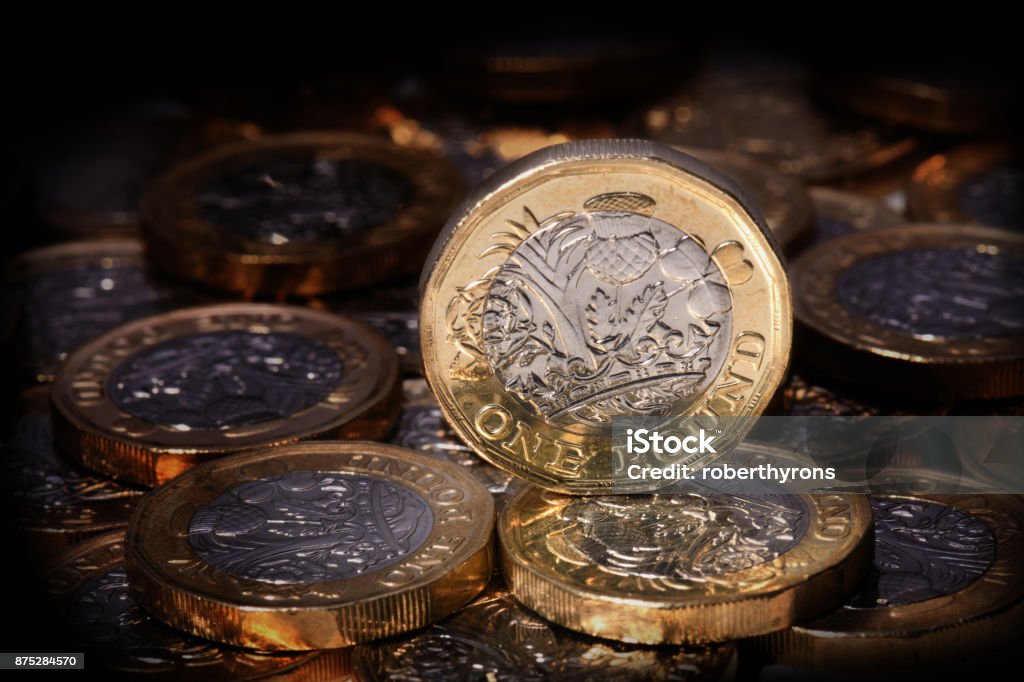 New one pound coin in a spotlight British Coin Stock Photo