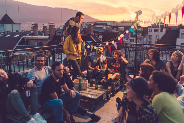 Social gathering on the rooftop Group of friends enjoying Friday night on the rooftop bulgaria photos stock pictures, royalty-free photos & images