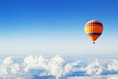 inspiration or travel background, hot air balloon over the clouds