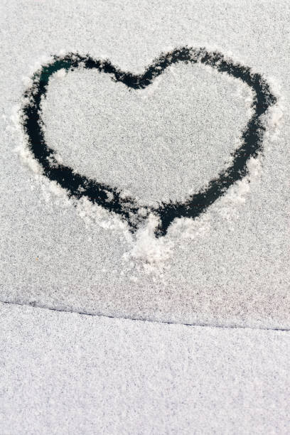 istock drawing hearts in the snow 875285568