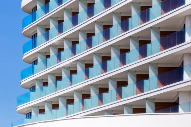 istock Rows of balconies in white apartment building 875286918