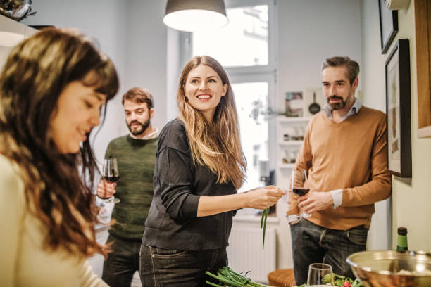 istock friends preparing food in kitchen 875290974