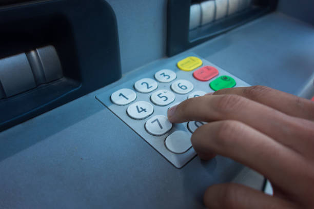 istock a man withdraws money from an ATM 875300116