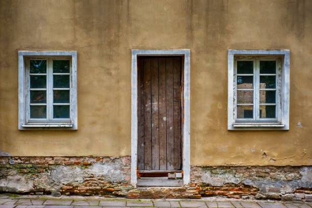 Old two windows and door with grunge cracked wall