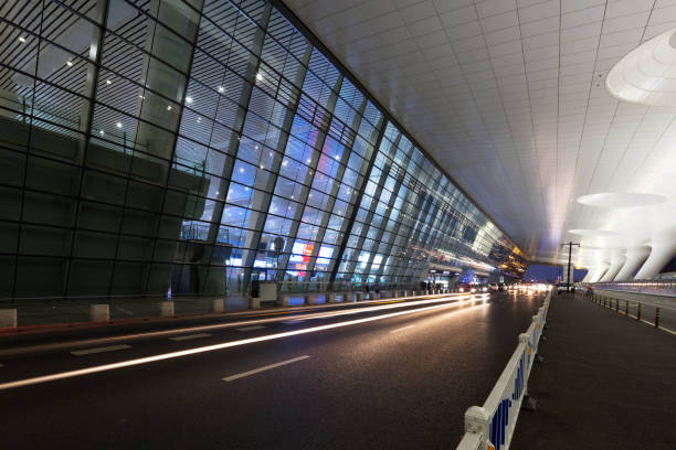 istock empty asphalt road by abstract modern building at night 875304988