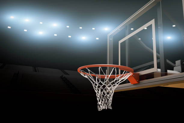 Basketball Stadium Background Copy Space A basketball stadium with basketball goal and bright stadium lights with copy space. college basketball court stock pictures, royalty-free photos & images