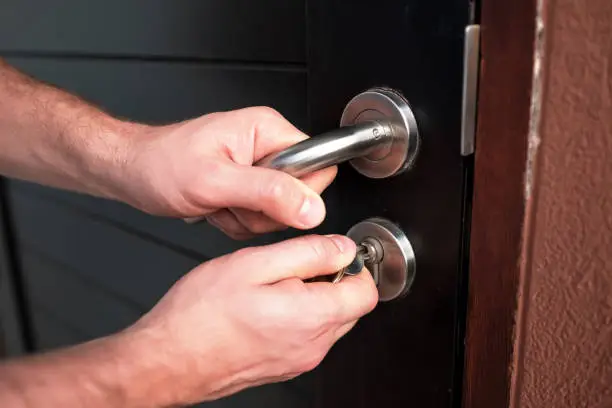 Photo of Man hand opening black door