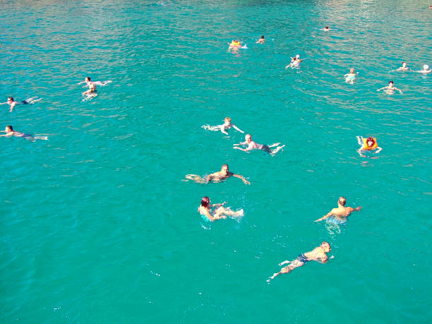 Kemer, Turkey - October 19, 2017 - Mass swimming of people in the Mediterranean, diving from the yacht.