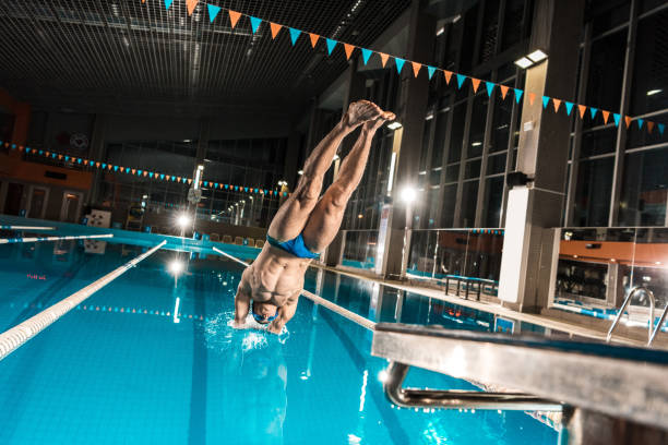 istock swimmer diving in swimming pool 875314118