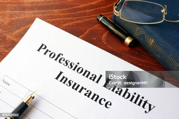 Professional Liability Insurance Policy On A Table Stock Photo - Download Image Now