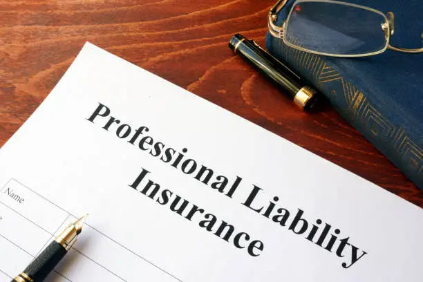 Photo of Professional liability insurance policy on a table.