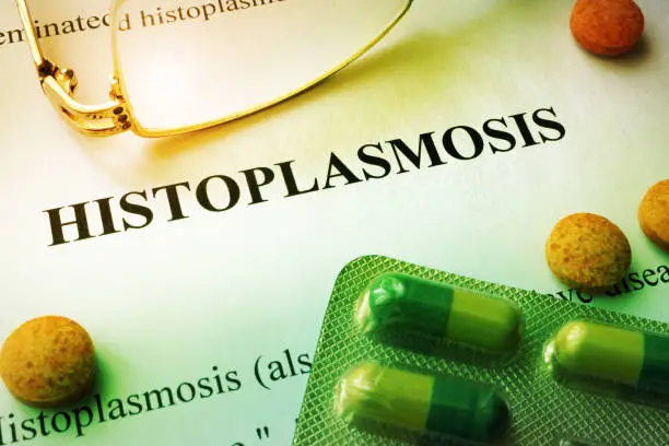 Photo of Page of book with title Histoplasmosis and tablets.