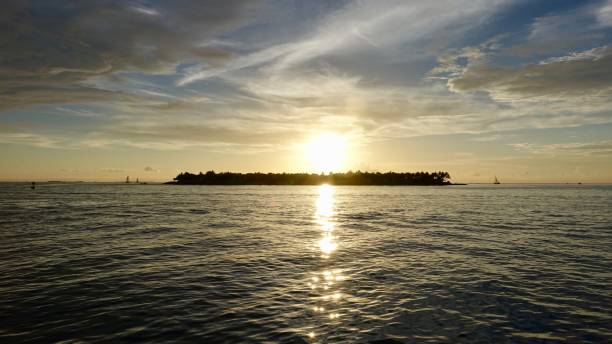 istock Sunset at the ocean, view towards little island 875323710